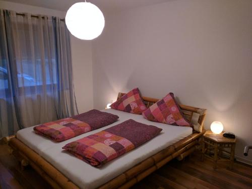 a bedroom with a bed with two pillows on it at Haus Bahlo - Ferienwohnungen in Attendorn