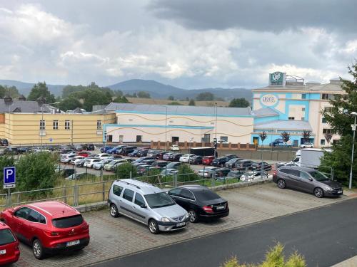 a parking lot with cars parked in front of a building at Private Apartment Rozvadov in Rozvadov