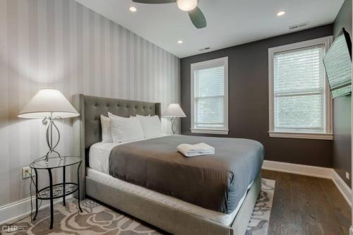 a bedroom with a large bed and two windows at Gold coast villa with free parking garage sleeps 10 in Chicago