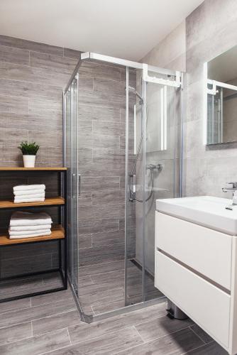 a bathroom with a shower and a sink at Galeria Apartments - Jasná in Demanovska Dolina