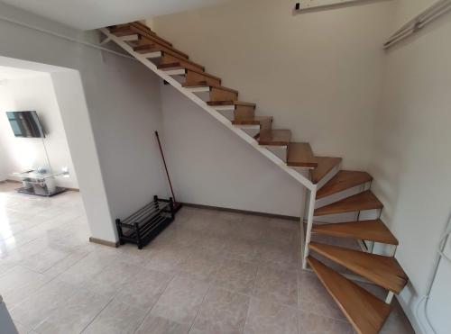 a staircase in a room with a tiled floor at Artemis Vendégház in Bogács