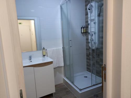 een badkamer met een douche en een wastafel bij Rustic House Fundão in Fundão