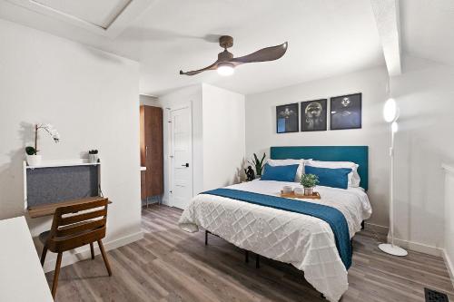 a bedroom with a blue bed and a television at Contemporary Couples Getaway Near Austin Favorites - Loft 21 in Austin