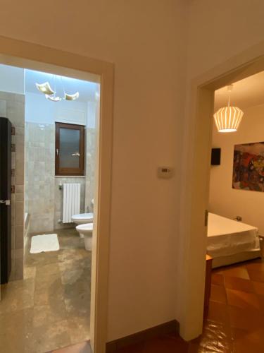 a bathroom with a bed and a toilet in a room at Villa Sterlizia in Veglie