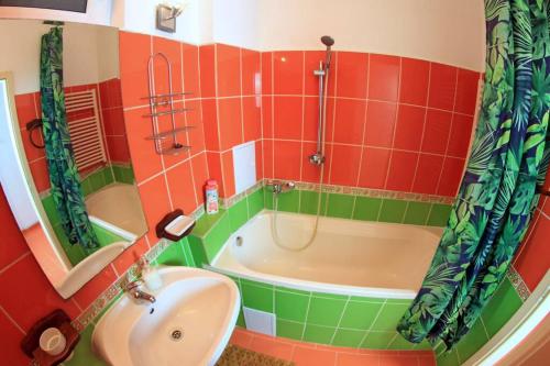 a bathroom with a tub and a sink at Rox Central Apartments 5 in Timişoara