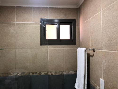 a bathroom with a window and a bath tub at Perito Moreno - 3ro A in Puerto Iguazú