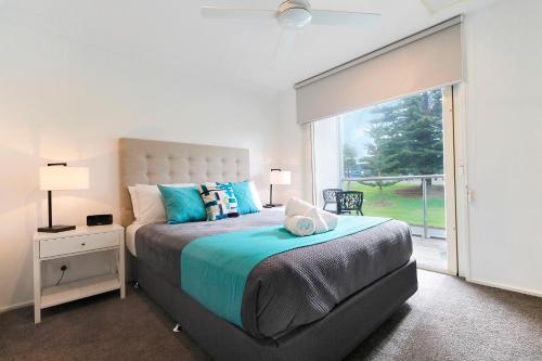 a bedroom with a large bed and a large window at Apartments 521 in Warrnambool