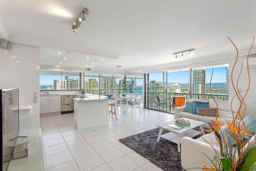 an open kitchen and living room with views of the city at De Ville Apartments in Gold Coast