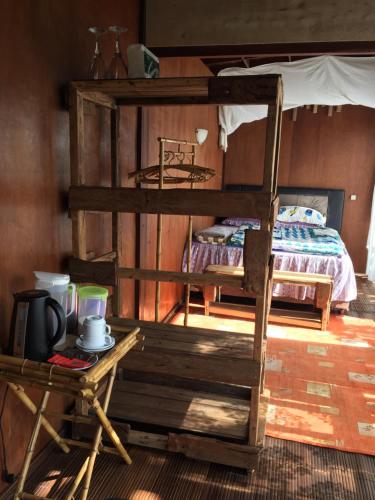 a bedroom with two bunk beds and a table at jungleadventure cabin camping in Bedugul