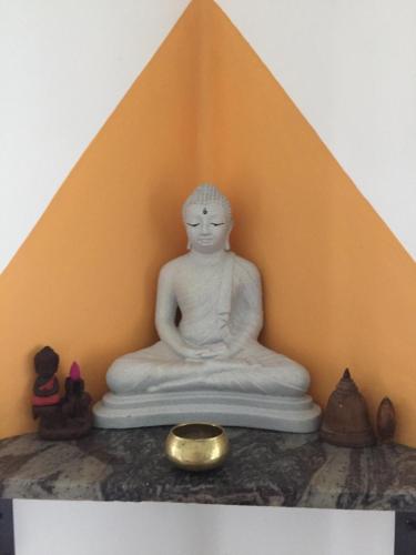 a buddha statue sitting on top of a pyramid at The Esence of Sri Lanka in Ahungalla