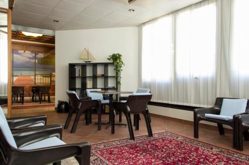 a living room with a table and chairs at Hotel Merano in Grado