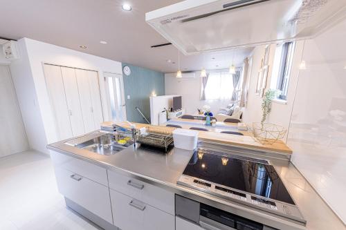 a kitchen with a sink and a stove top oven at ID STAY7 in Fujikawaguchiko