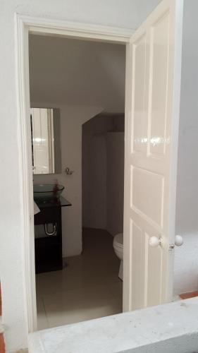 an open door to a bathroom with a toilet at Casa Horizonte Azul Acapulco in Acapulco