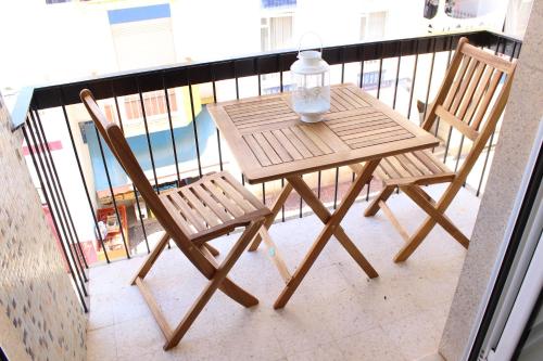a wooden table and two chairs on a balcony at Casa Da Baía in Lagos