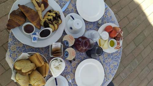 a table with plates of food on top of it at Valdorcia Belvedere b&b in Pienza