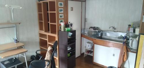 a small kitchen with a sink and a counter at Tama Ryokan in Tokyo