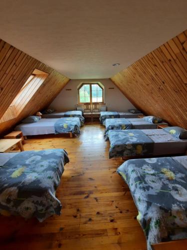 a row of beds in a room with a attic at Jaun-Ieviņas in Rauna