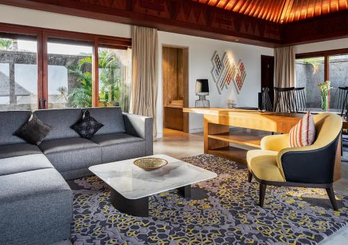 a living room with a couch and a table at The Edge Bali in Uluwatu