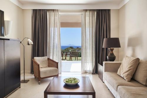 a living room with a couch and a table at Atlantica Belvedere Resort - Adults Only in Kardamaina