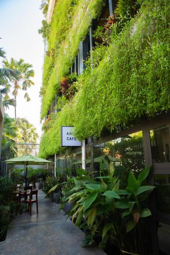 a building with plants on the side of it at Indra Hotel in Phnom Penh