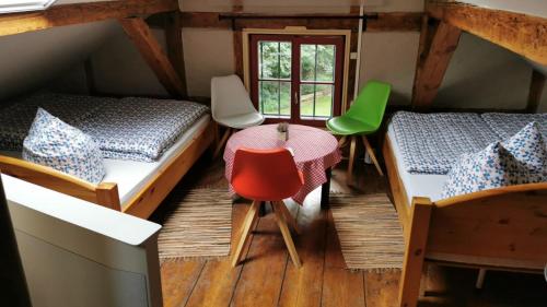a room with two beds and a table and chairs at Forsthaus Leiner Berg in Dessau