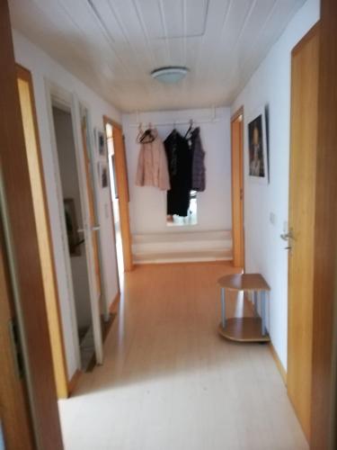 a hallway in a house with clothes hanging on the wall at Ferienwohnung / Monteurswohnung in ruhiger Waldlage in Borghees