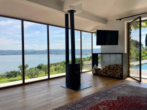 a living room with a fireplace and a view of the water at Villa The View in Koper