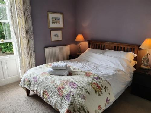 里彭的住宿－The Bruce Arms，一间卧室配有一张带花卉毯子的床