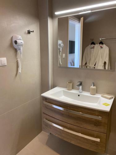 a bathroom with a sink and a mirror at Luminous Luxury Apartments in Limenas