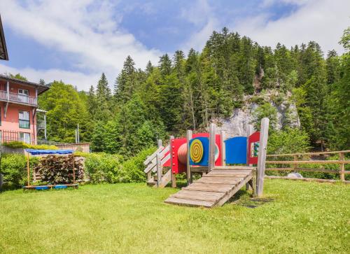 a playground in a yard with a wooden bridge at JUFA Hotel Altaussee in Altaussee