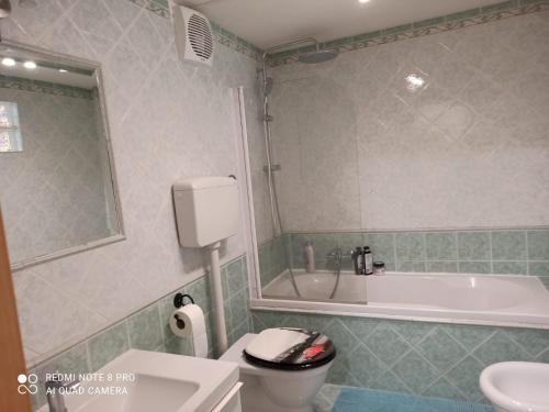 uma casa de banho com uma banheira, um WC e um lavatório. em Il cantuccio di Diana em Nápoles