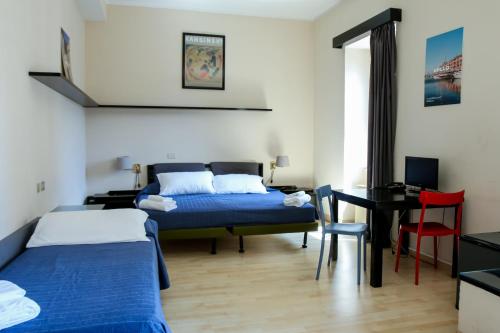 Ένα ή περισσότερα κρεβάτια σε δωμάτιο στο Hotel Britannia