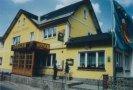 a yellow house sitting on the side of a street at Hotel-Gasthaus Steiger in Gräfenthal