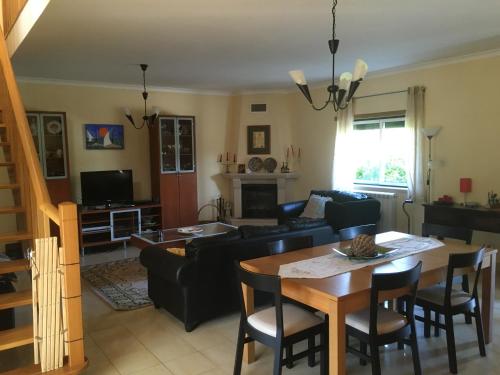 a living room with a couch and a table at Paraíso do Quim in São Martinho do Porto