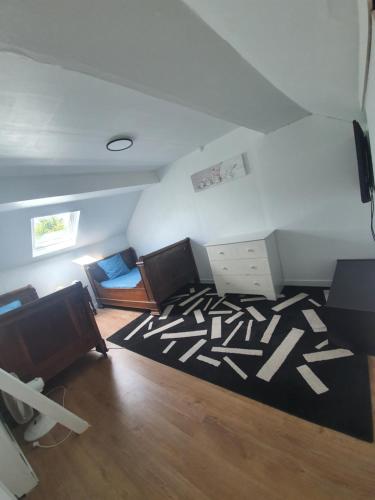 an attic room with a couch and a desk at Gîte de Montapeine 8 in Breteau