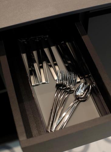 a group of silver forks and spoons in a drawer at Fetén in Valencia