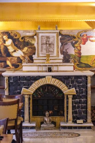 a room with a fireplace with a painting on the wall at Oğlakcıoğlu Park Otel in Izmir
