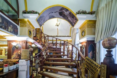 a staircase in a building with a painting on the wall at Oğlakcıoğlu Park Otel in Izmir