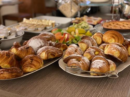 a table with two plates of pastries and other foods at Hotel Palazzo Benci in Florence