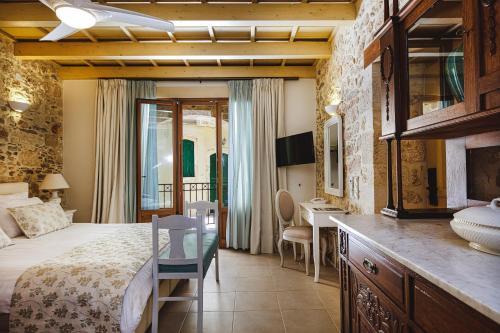 a bedroom with a bed and a desk in a room at Z Boutique Hotel in Panormos Rethymno