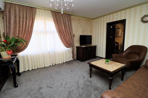 a living room with a couch and a table at aSa Boutique Hotel in Haskovo