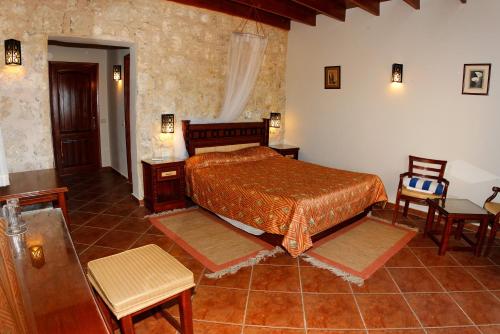 a bedroom with a bed and a table and chairs at The Oasis in Abu Dabbab