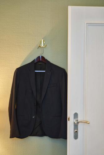 a suit jacket hanging on a wall next to a door at Hotel Monopol - Central Station in Frankfurt/Main