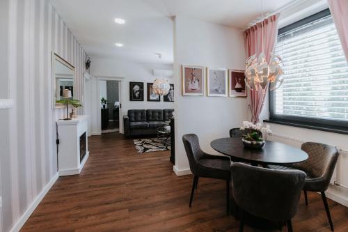 a living room with a table and chairs at Apartmány Evia clinic in Levice