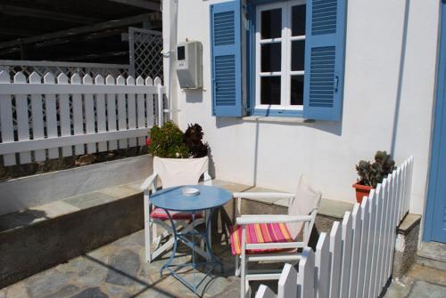 a table and chairs sitting outside of a house at Kyprianos house in Platis Yialos Sifnos