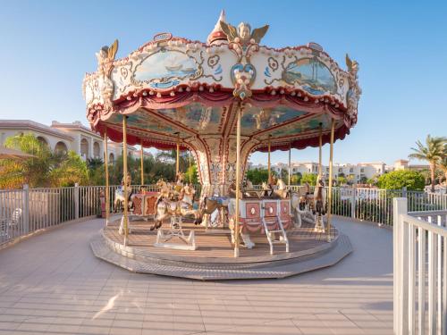 a carousel at a resort with people on it at Serenity Alma Heights - Ex Serenity Fun City in Hurghada