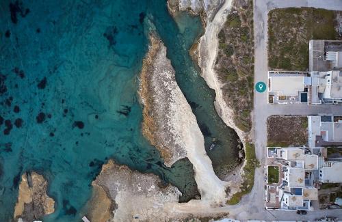 an aerial view of a beach and the ocean at Villa Costa Mare Milos - Delmar Collection in Pollonia