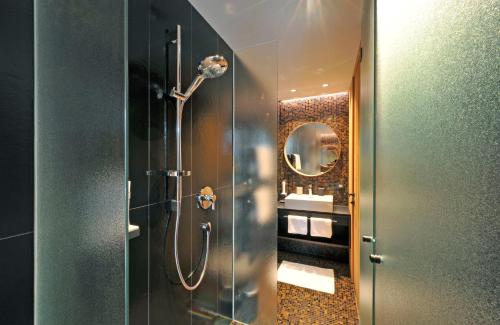 a bathroom with a shower and a mirror at Ferienparadies Natterer See in Innsbruck