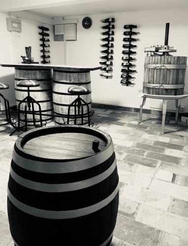 a room with wine barrels and a table and chairs at REnthouse - Ferienhaus am Weinberg in Rechnitz