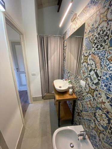 a bathroom with a sink and a mirror at La Magnolia in Greve in Chianti